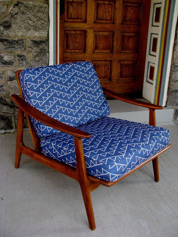 a bold mid century modern chair with a rich stained frame and legs plus bright printed upholstery will make a statement with its color and print