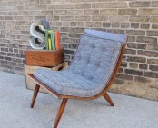 a creative grey mid-century modern chair with a stained frame and grey upholstery is a stylish idea for a cozy modern space