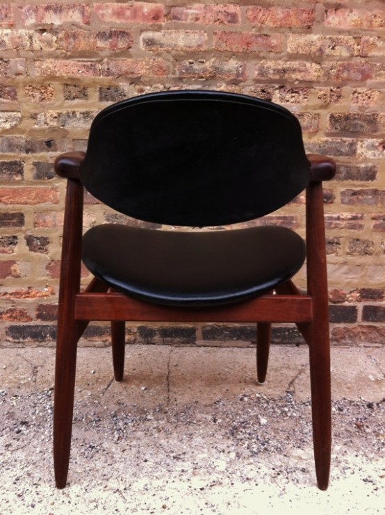 a catchy mid-century modern chair with a rich-stained frame and legs and a black leather back and seat is a cool and stylish idea