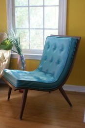 a cool mid-century modern chair with a stained base and legs plus blue diamond upholstery on top is a very catchy and cool idea
