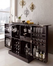 a dark stained refined wooden home bar with everything necessary for making cocktails and drinks is a stylish option to rock