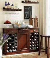 an elegant dark stained vintage home bar with closed and open storage compartments and matching open shelves over it creates a whole bar space