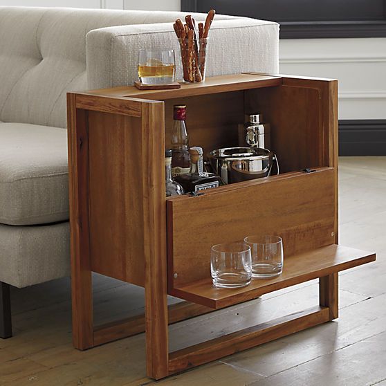 a wooden side table that doubles as a home bar is a cool piece that won't take much space and will give you enough space for drinks