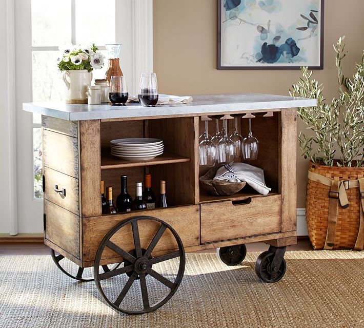 a vintage rustic bar cart of crate wood, with large wheels and a marble countertop plus white blooms
