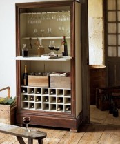 a dark stained vintage home bar with open and closed storage compartments looks chic and refined