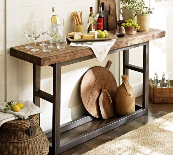 a simple home bar of a rustic wooden console table with greenery, some wine and appetizers is perfect