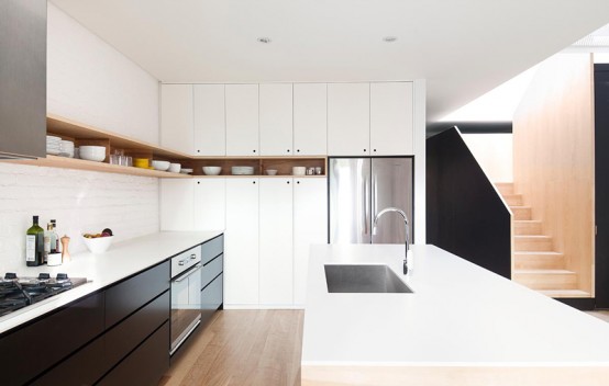 Minimal Black And White Kitchen With A White Brick Wall