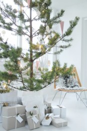 an oversized potted pine tree with black and white ornaments plus lights is a lovely idea for a serene modern or Scandi space