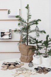small potted pine trees decorated with himmeli and plywood ornaments look amazing and very simple and will do for a minimalist or Scandinavian space