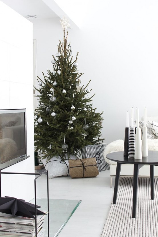 a simple Christmas tree decorated with only sheer and silver Christmas ornaments is a lovely idea for a minimalist or Scandi space