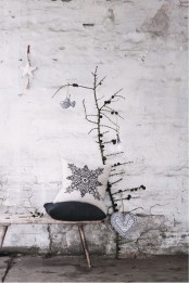 a dried branch with pinecones and two fabric ornaments – a bird and a heart for a minimal Nordic look