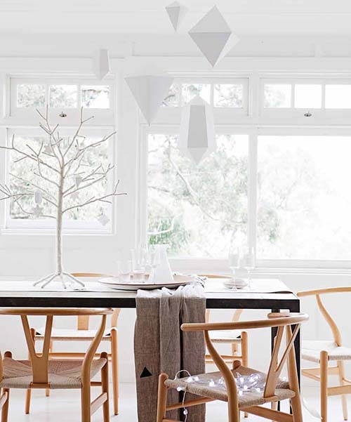 white 3D paper ornaments hanging over the table will give a slight minimalist and holiday feel