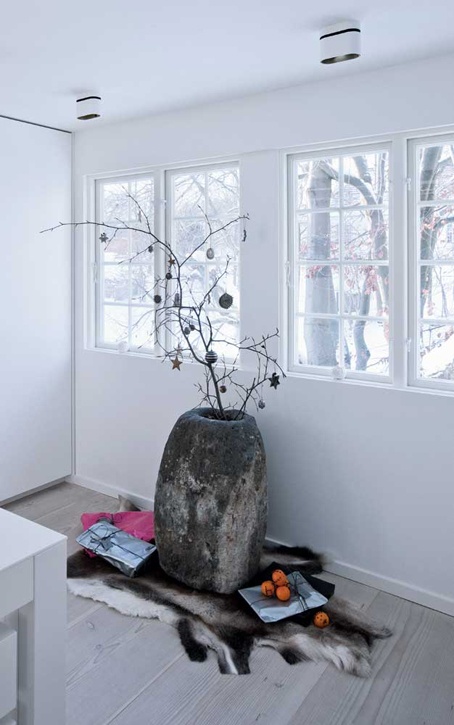 tree branches in a textural pot and some dakr ornaments will bring a holiday feel to the space