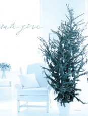 a Christmas tree in a white pot with white stars and icicle ornaments for a minimalist space