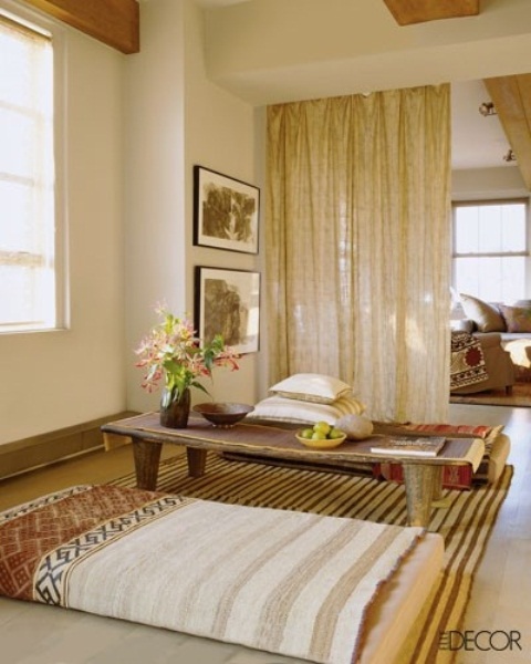 a boho chic meditation space with pillows and a low table that can be removed to meditate