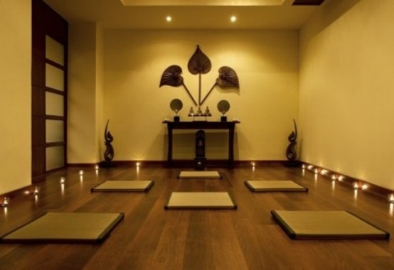 a contemporary meditation room with an Asian feel and rugs and minimal furniture