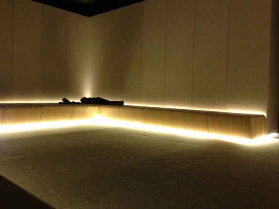 a minimalist meditation room fully clad with plywood and with inner lights 