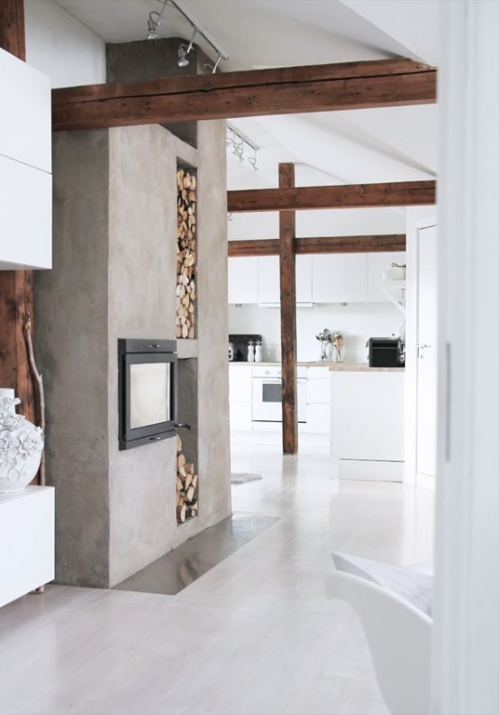 a sleek neutral space with white walls and dark-stained beams, a built-in fireplace, a sleek floor and a firewood storage niche
