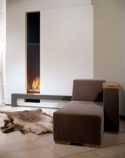 a neutral contemporary living room with neutral walls, a brown daybed with a built-in vertical fireplace plus a dark bench are great
