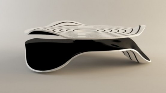 a black and white coffee table of a quirky irregular shape and with no legs but parts of the tabletop is cool