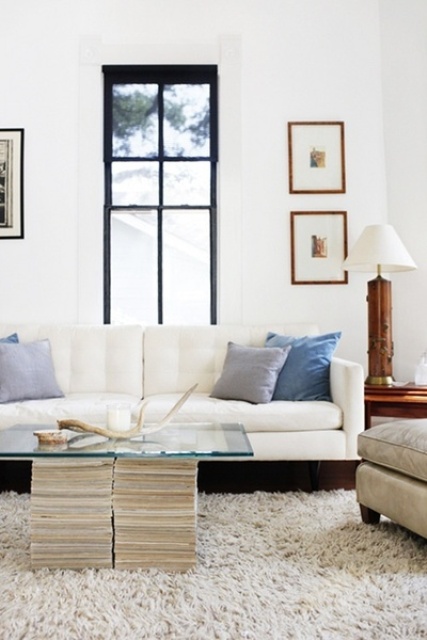 a creative coffee table of stacks of magazines and a glass tabletop is a lovely idea that doesn't spoil your home decor