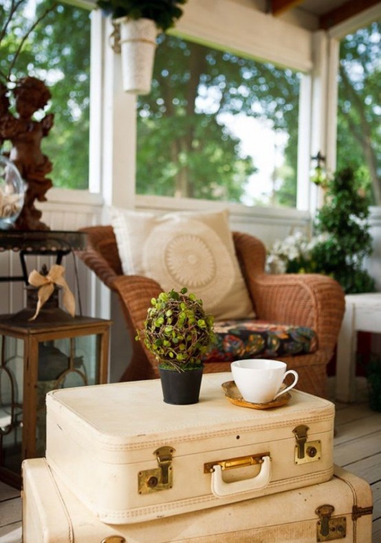 a neutral coffee table created of a stack of suitcases is a lovely and creative idea for a vintage or shabby chic space