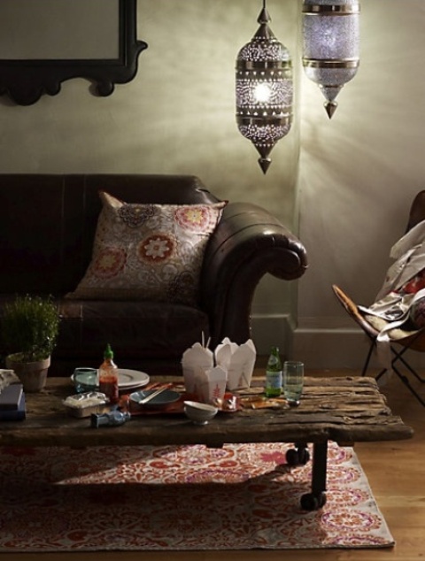 a rustic coffee table of a very rough piece of wood on casters is a cool idea for many spaces, from rustic to boho ones