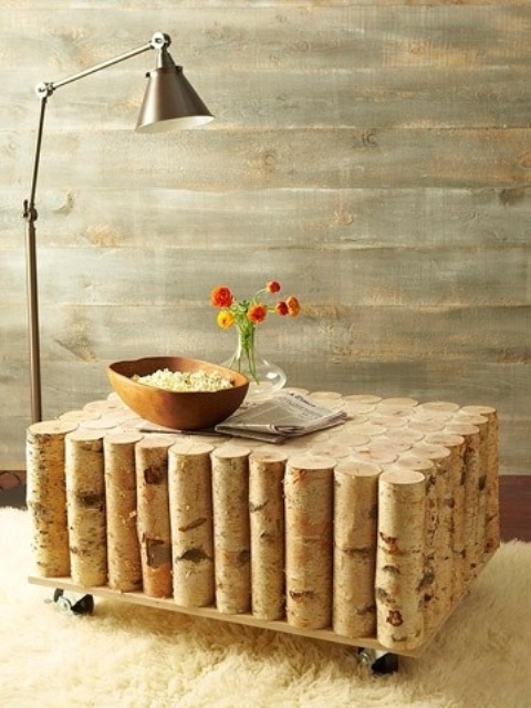 a creative rustic coffee table of birch trunks, wood on casters is a lovely idea for a rustic interior