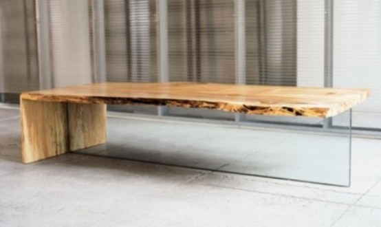 a modern coffee table with a glass base and a wooden waterfall tabletop is a stylish idea for a modern living room