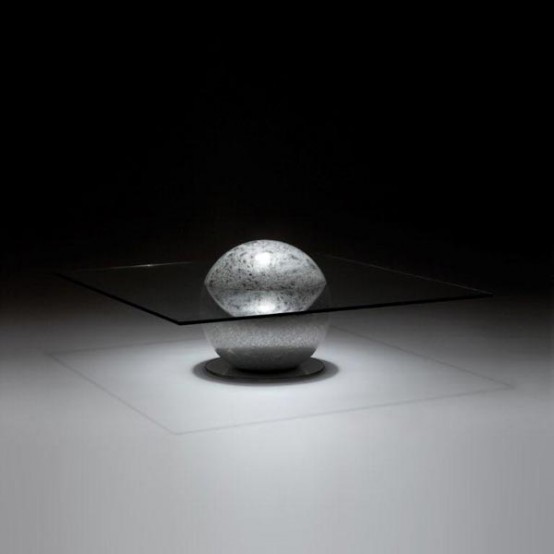 a creative coffee table of a metal ball and a glass tabletop is a stylish and chic idea for a contemporary or minimalist space