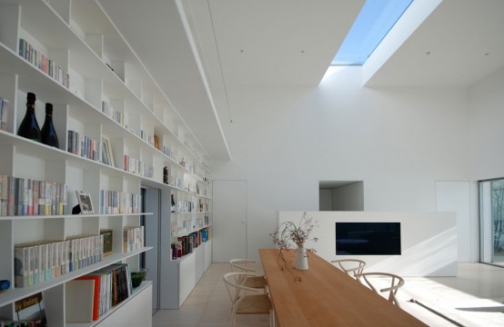 a modern and minimal home library with built-in bookshelves and a large desk where you can read, skylights will give much light