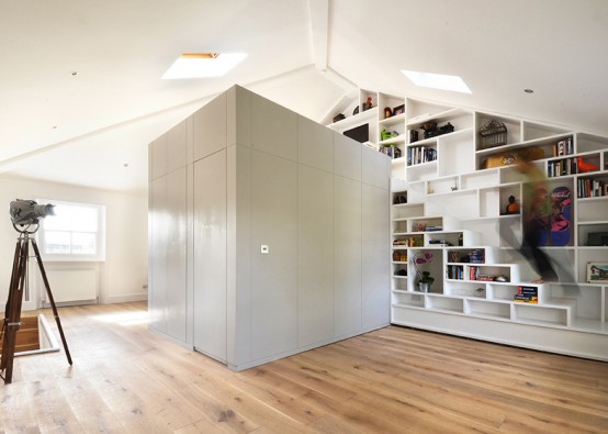 a modern home library with built-in bookshelves placed on the wall and reaching the ceiling