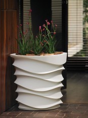 a white patterned tall planter will accent your blooms or greenery and will add a modern feel to the space
