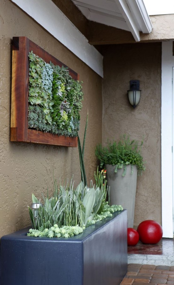 a long black porcelain planter with greenery and succulents is a cool idea for a modern outdoor space