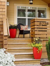 tall red planters with greenery and blooms will accent your space with a touch of color and will make it bright and fun