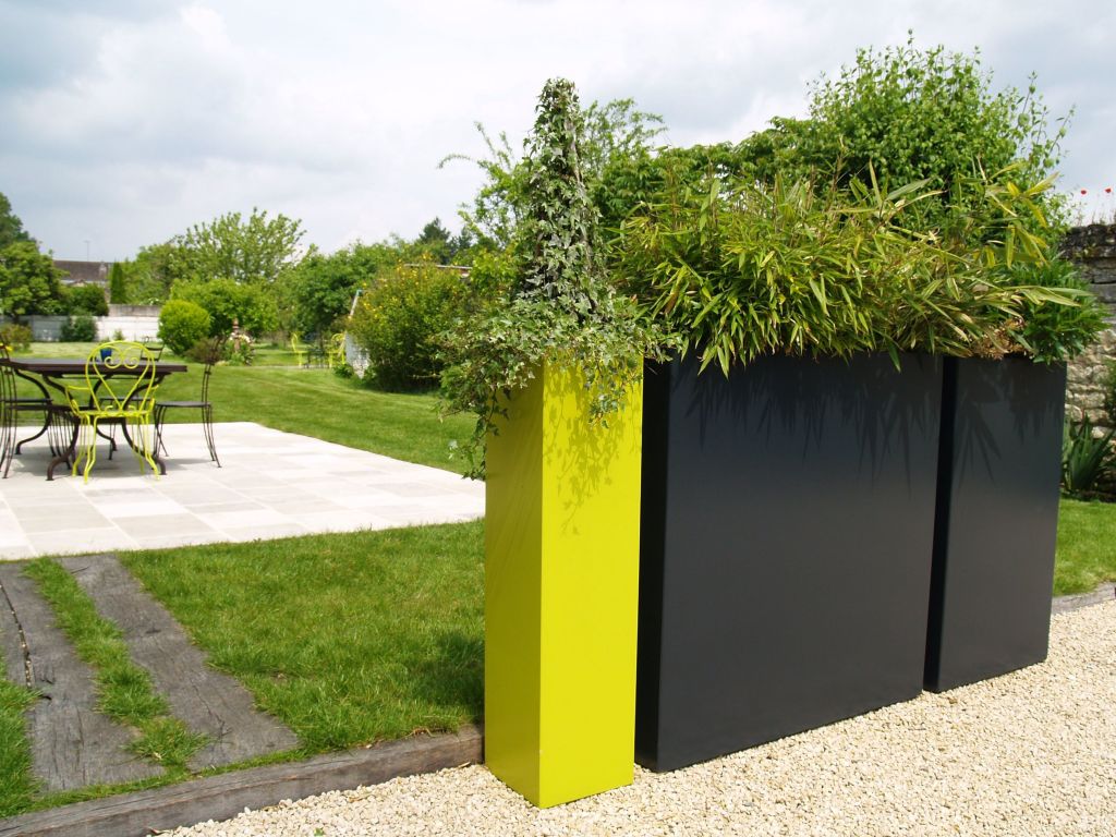 tall square black and neon yellow plants like these ones are sure to display your plants at their best and can separate the spaces