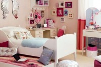 a bright pink and red teen girl bedroom with a gallery wall, striped textiles and various accessories