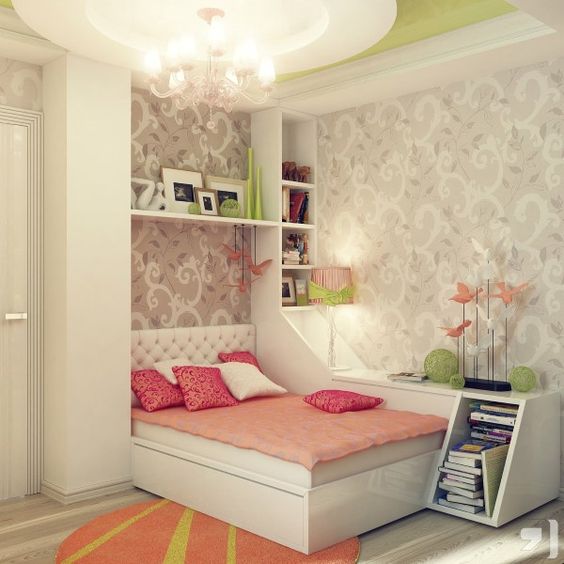 a refined teen girl bedroom with printed wallpaper, neutral furniture, coral and pink bedding and touches of neon green