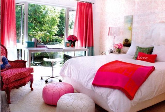 a colorful teen girl bedroom in light pink with hot pink and red touches and various prints is very bright