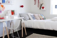 a cool and fun teen girl bedroom with layered rugs and colorful touches is a bright and welcoming space