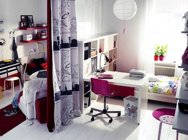 a bright teen girl bedroom - a neutral base spruced up with bright pink, red and black touches and a space divider for sharing the room