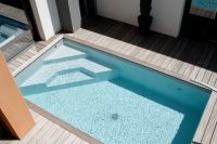 modern wooden deck with a small outdoor pool