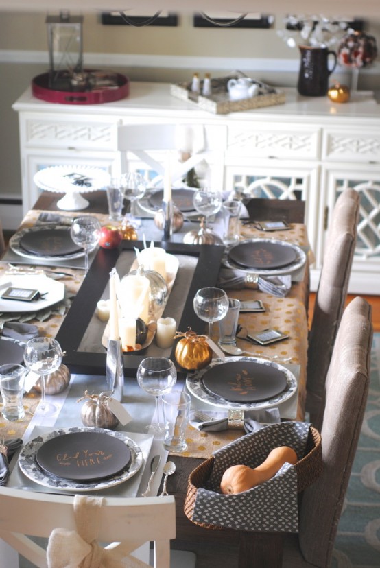 a modern and chic Thanksgiving tablescape with a candle centerpiece, printed and black plates, polka dot placemats is amazing