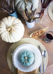 a modern farmhouse Thanksgiving tablescape with pale and pastel pumpkins, feathers and pastel porcelain is very chic
