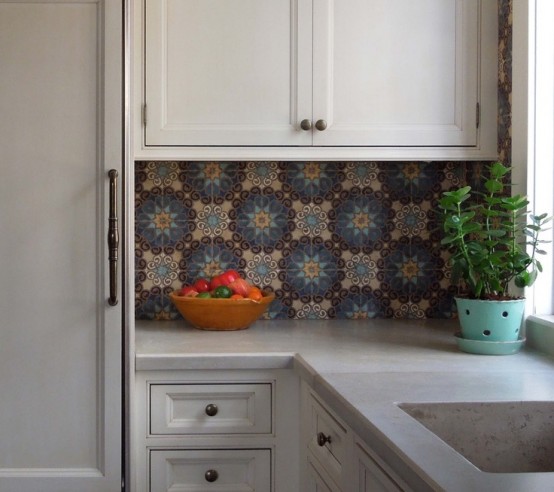 a modern neutral kitchen with shaker style cabinets and black knobs, with a colorful Moroccan pattern tile backsplash that adds interest and eye-catchiness to the space