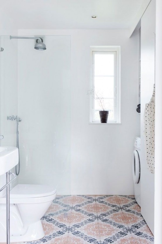 a small white bathroom with white walls, a Moroccan tile floor, white appliances and a small window is a lovely space with a touch of color