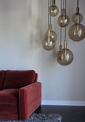 beautiful smoked glass bubble pendant lamps with gold touches hung in cluster are amazing to spruc eup a modern or contemporary space