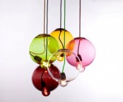 colorful round glass lamps with bulbs hanging out of them will make your space look unique, cool and bold