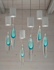 white pendant lamps and blue or truquoise pendants shaped as drops are amazing to rock them in any bold space