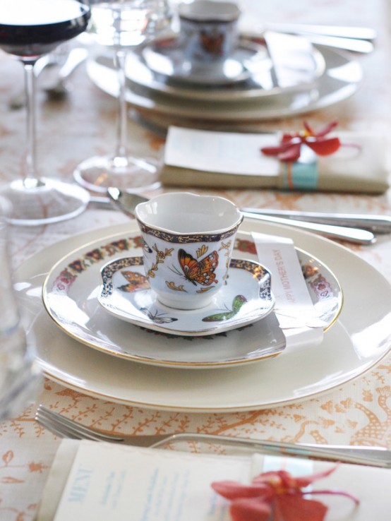 a pretty Mother's Day tablescape with a printed tablecloth, white and printed porcelain, silver cutlery